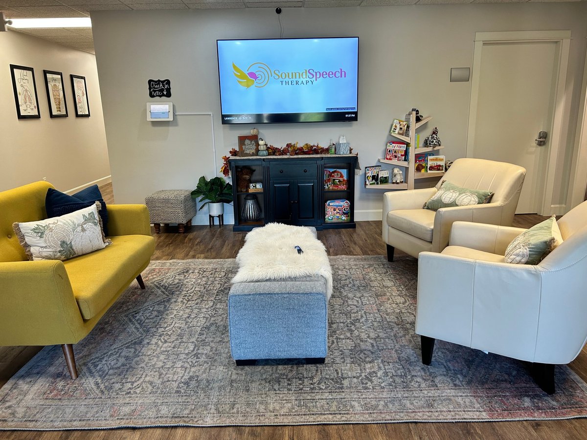 New Heights Therapy lobby with yellow and cream chairs, a blue ottoman and wooden storage furniture