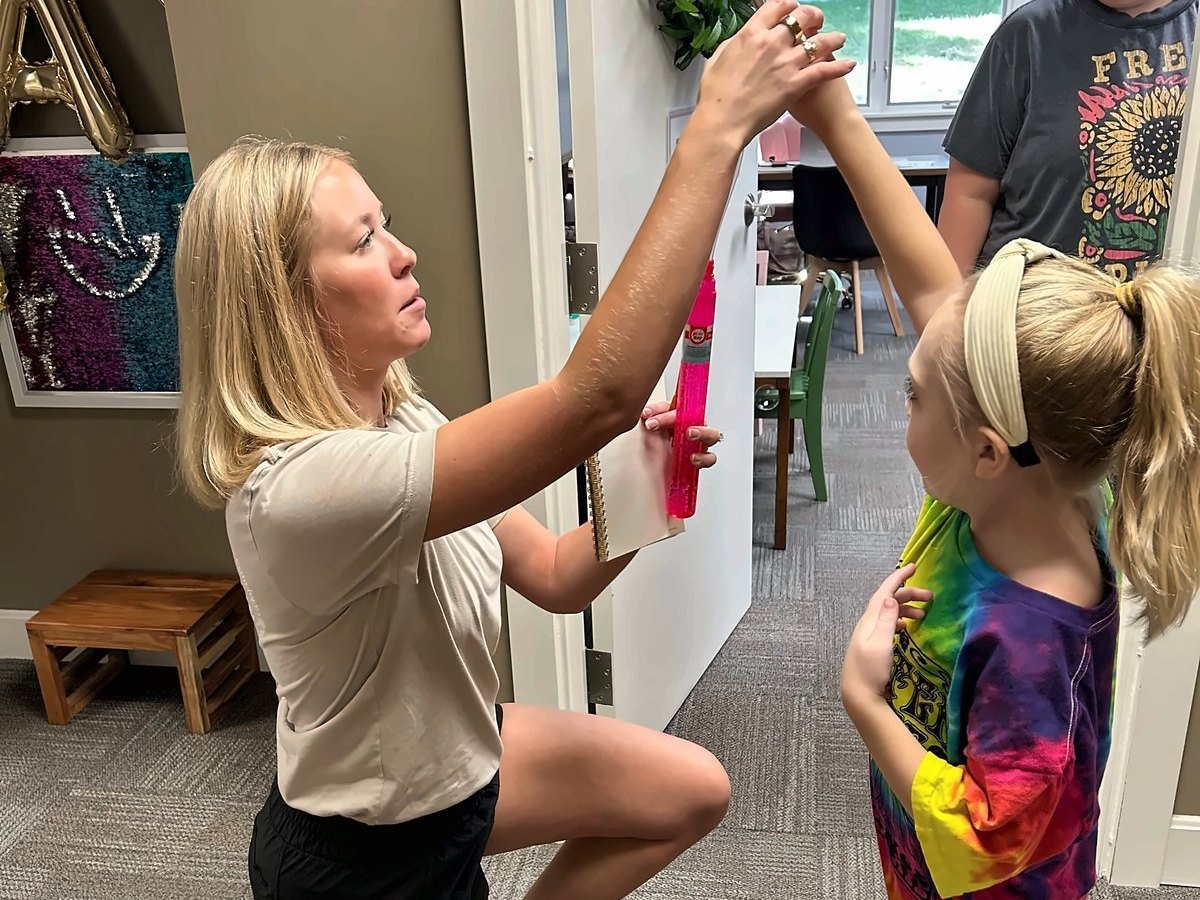 Shoulder range of motion check during a pediatric physical therapy evaluation at New Heights Therapy